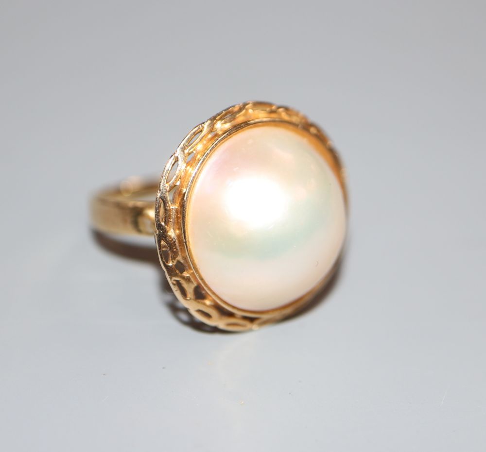 A 585 yellow metal and mabe pearl dress ring, size L, gross 5.2 grams.